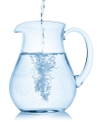 Water pouring into a pitcher, isolated on the white background, clipping path included.